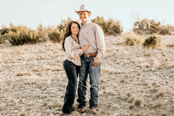 Kate and Morgan Hodges smiling together in a scenic outdoor setting.
