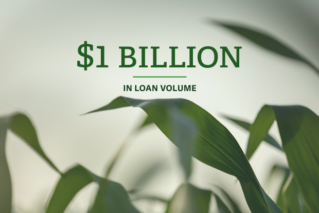 Grass with text that reads $1 billion in loan volume