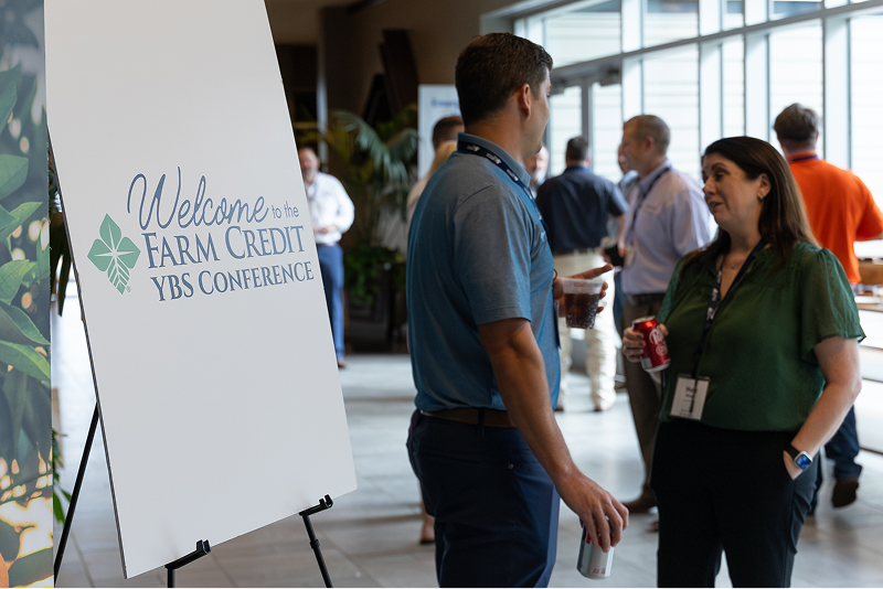 Two people chatting at a farm credit YBS conference