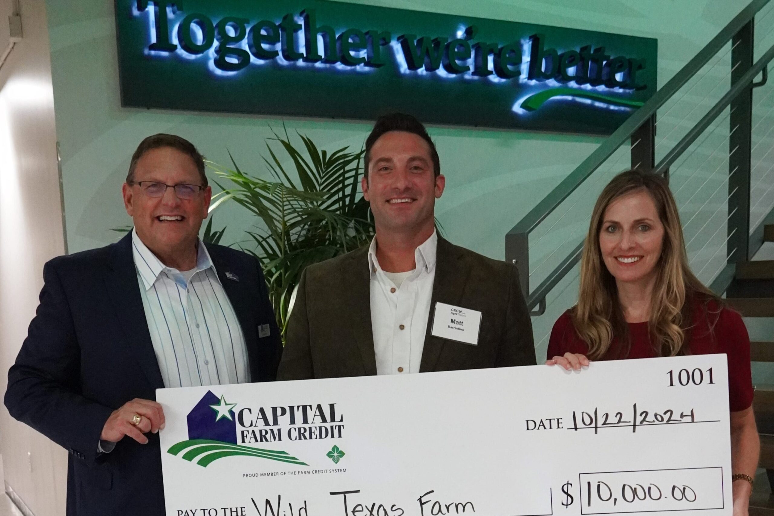 Wild Texan Farm representatives receive a $10,000 check