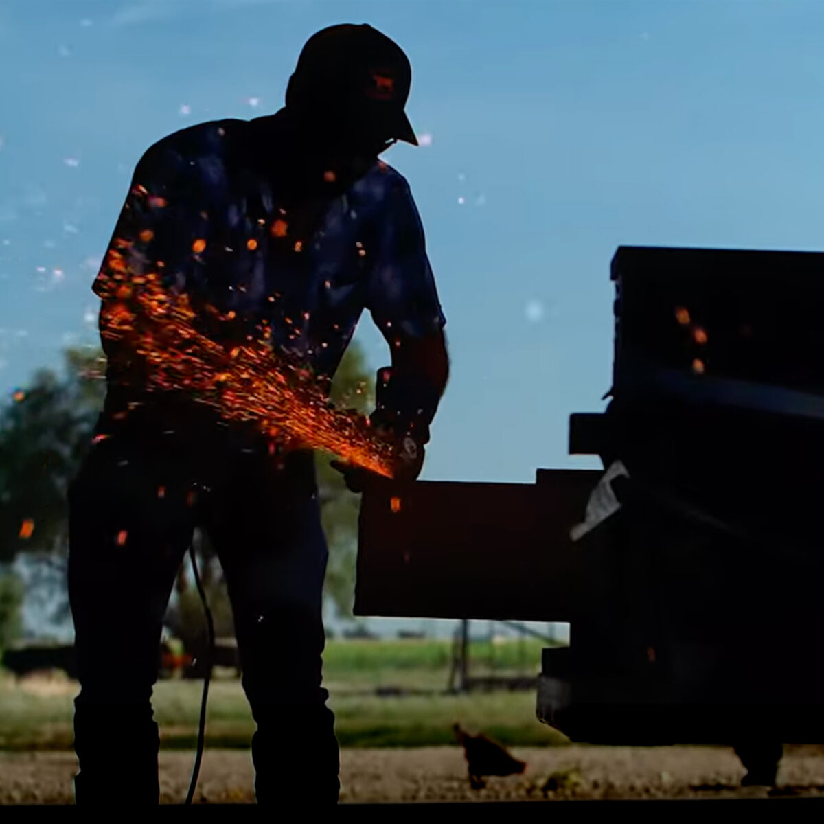 farmer Tyler Black working with power tools out of the bed of his pickup truck