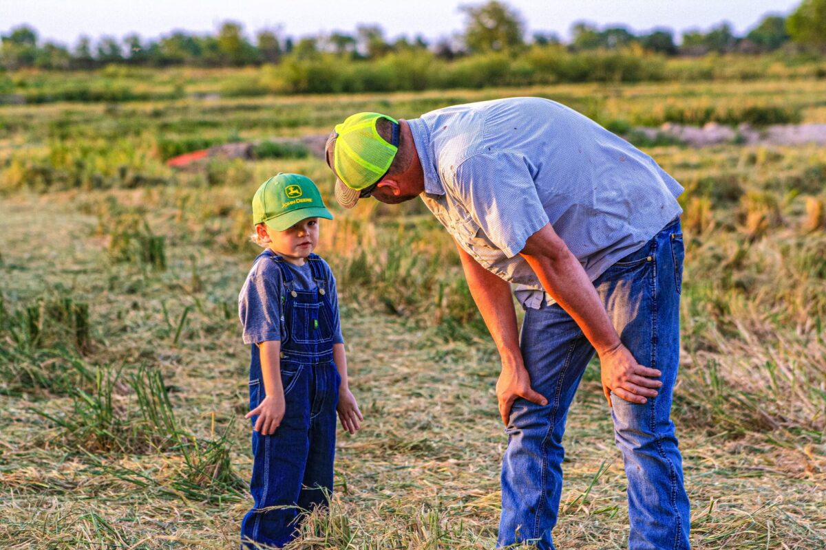 Father and son on a farm field.